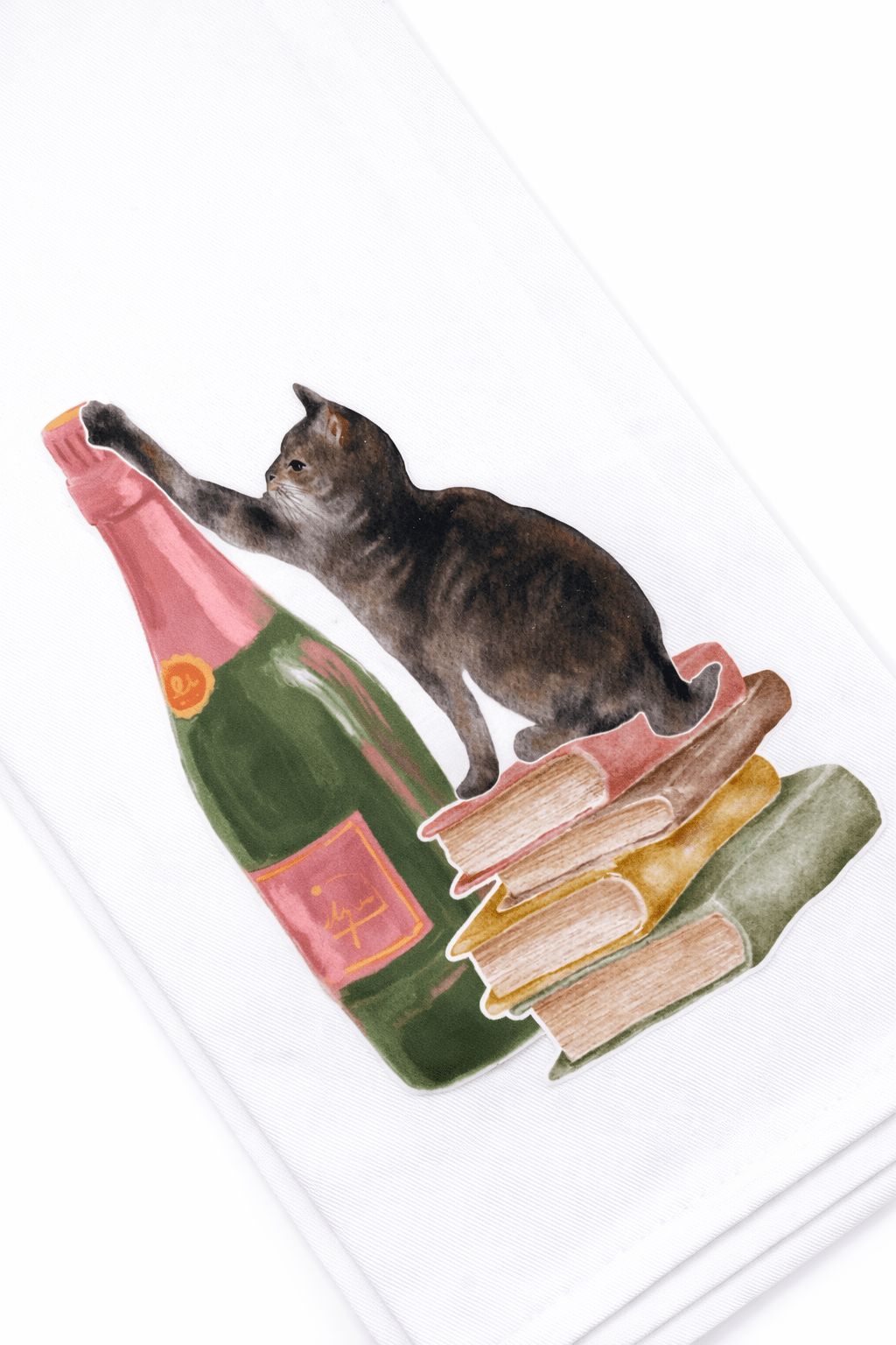 Cat playing with a bottle and books on a white background