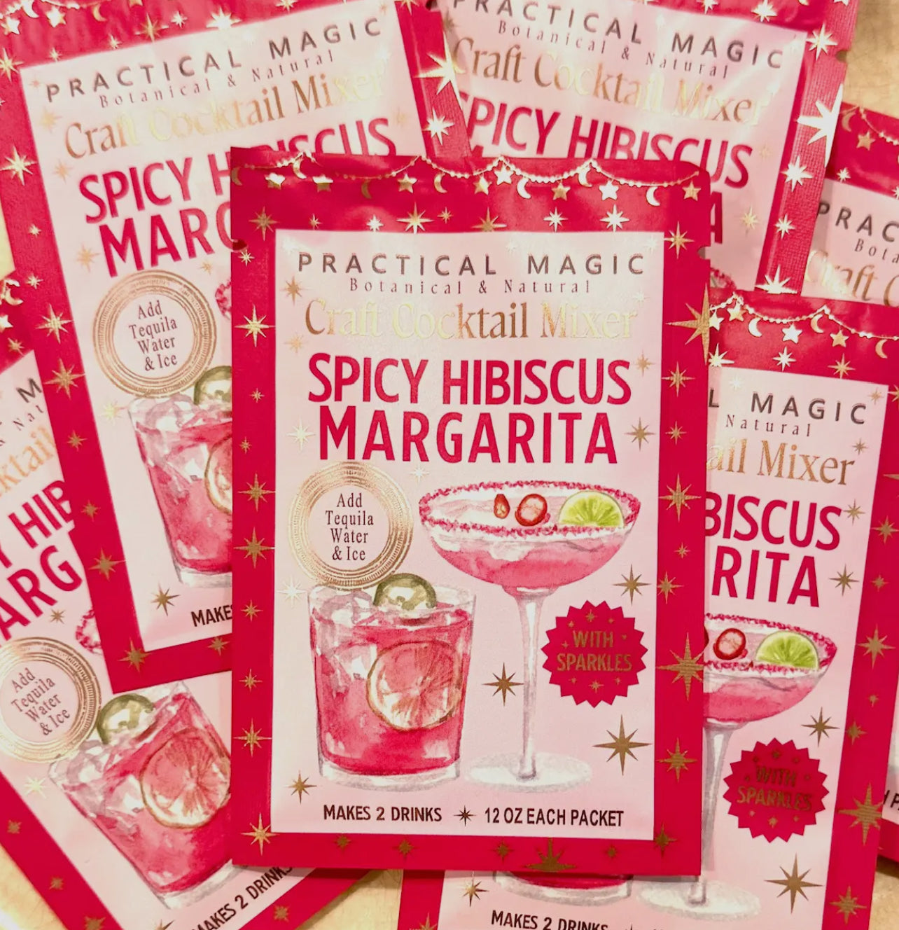 Spicy Hibiscus Margarita cocktail mix packets on a red background
