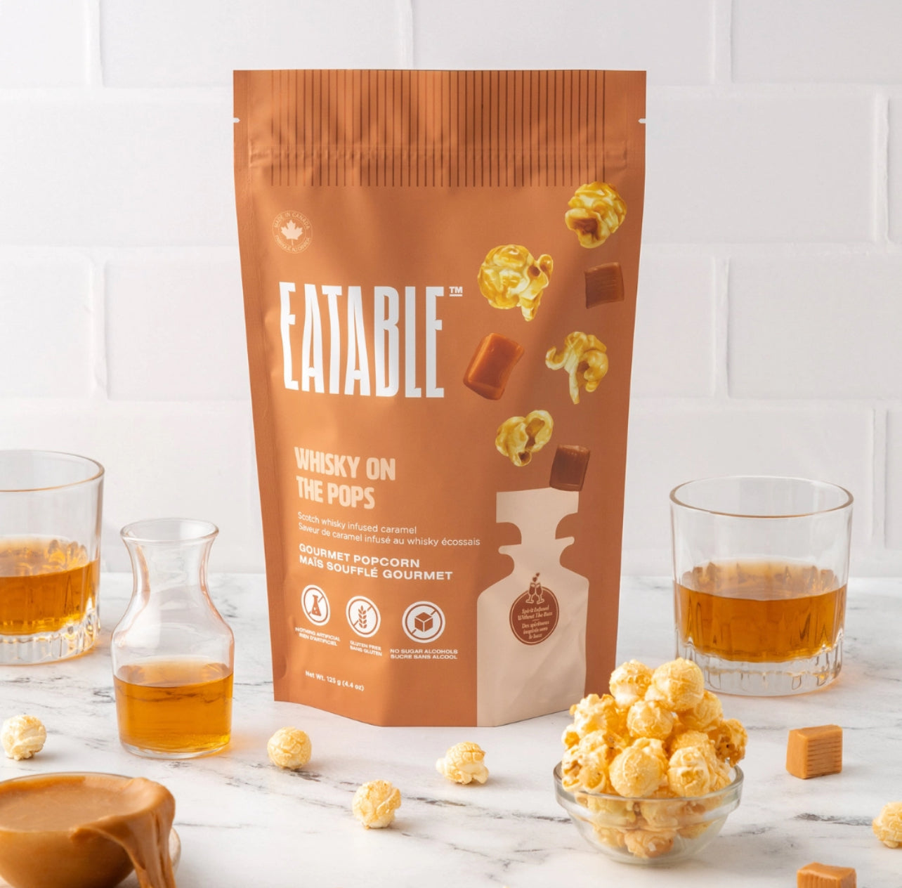 Eatable Whisky on the Pops product packaging with popcorn and caramel on a white background