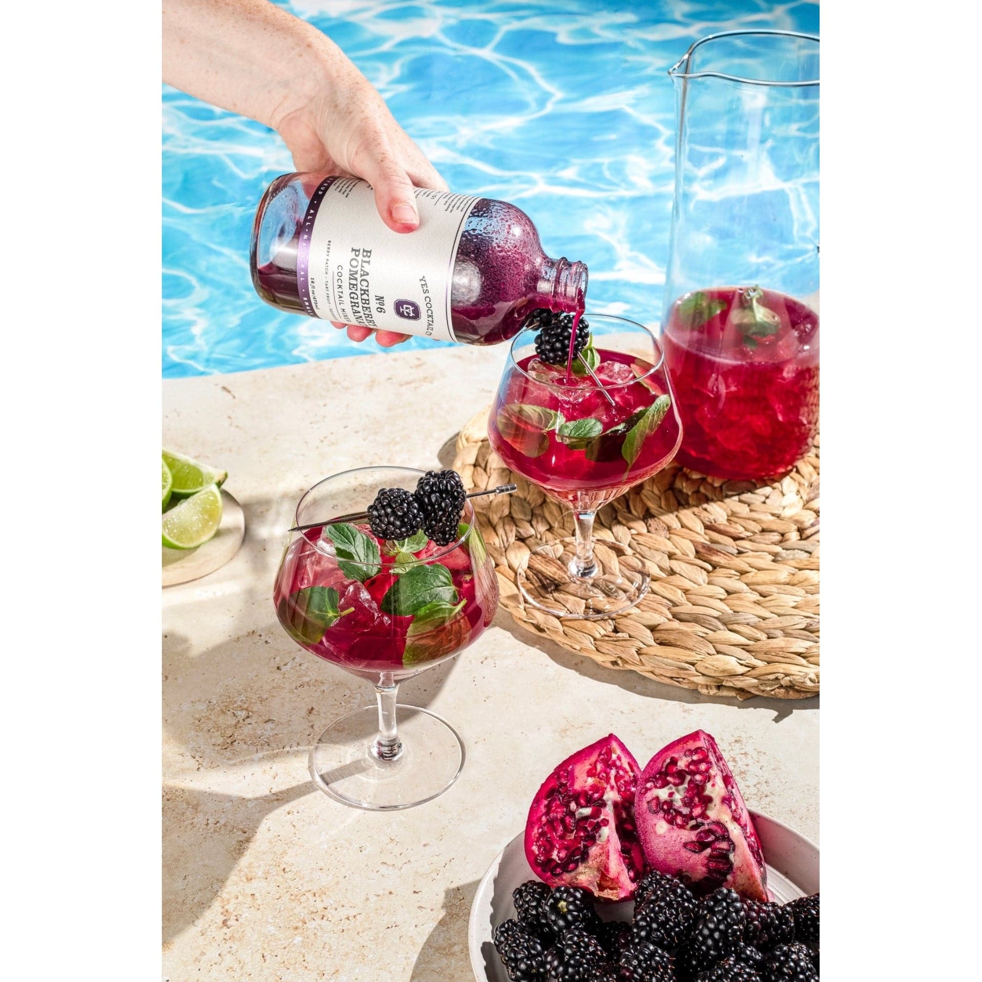 man pouring cocktail mix into a glass