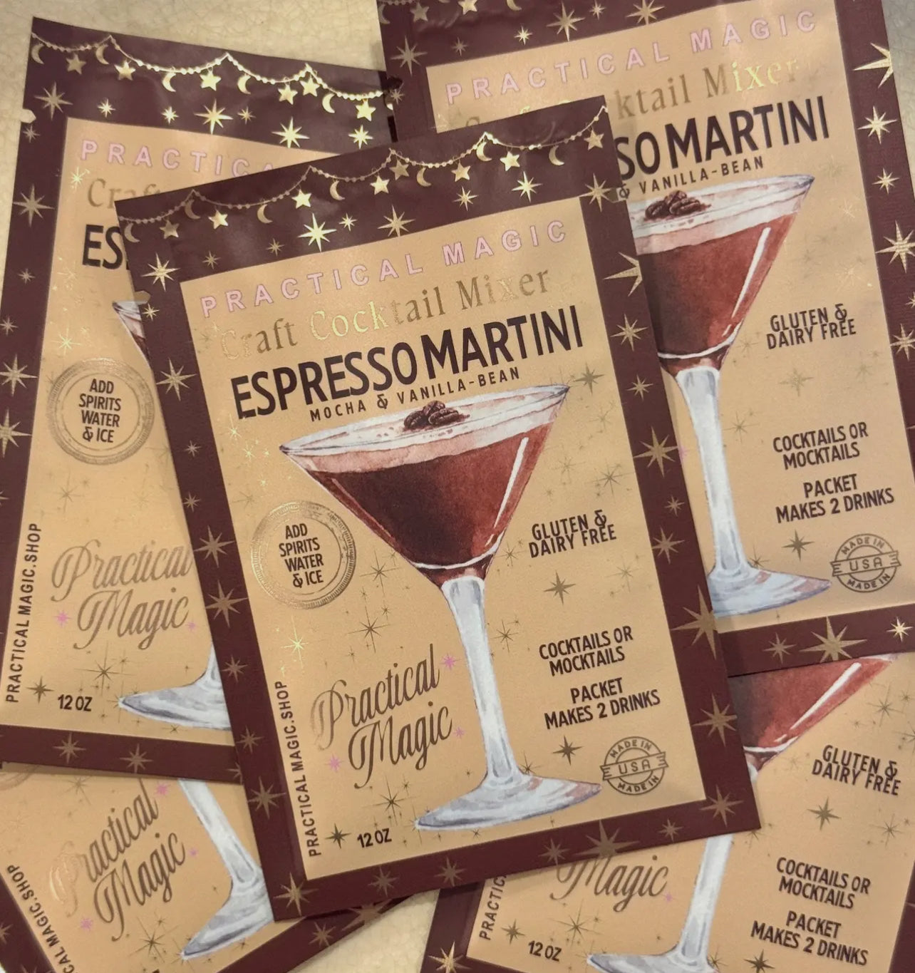 Practical Magic Espresso Martini cocktail mixer packets on a matching background