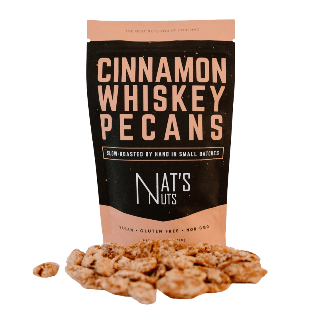 A package of Cinnamon Whiskey Pecans by Nat's Nuts, with some pecans visible in front of the package, indicating the product is vegan, gluten-free, and non-GMO.