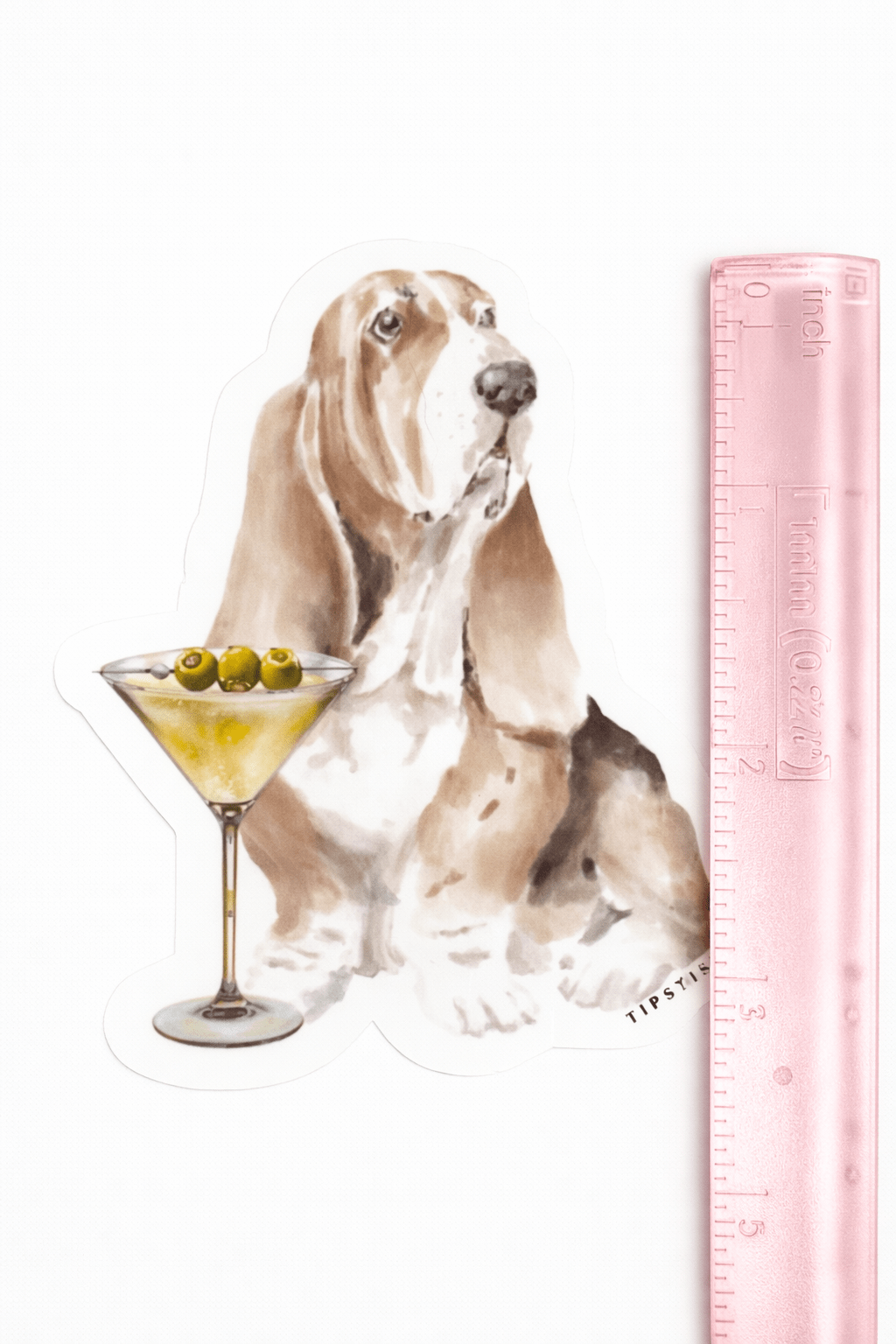 Sticker of a dog with a cocktail and a ruler for scale on a white background