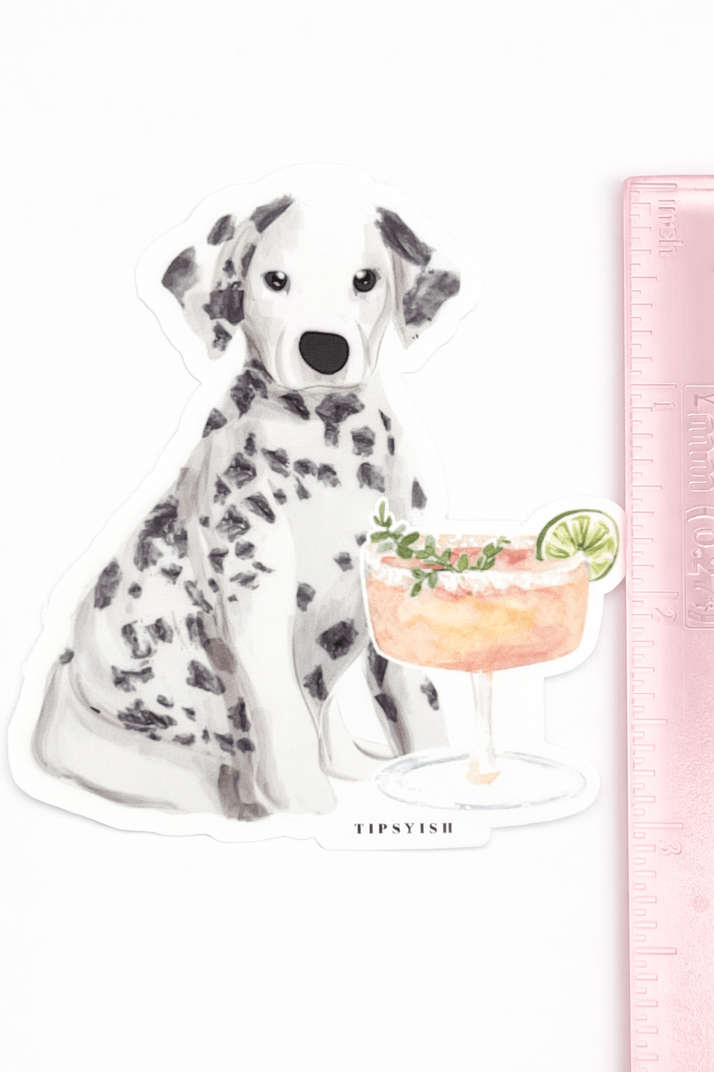 Sticker of a Dalmatian dog with a cocktail next to a ruler for scale