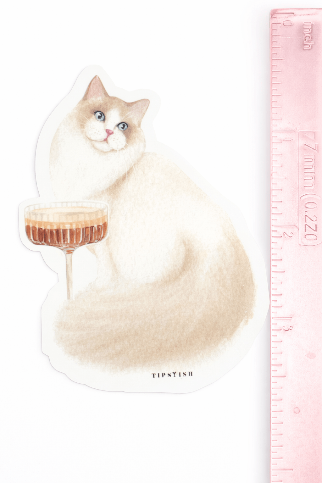 Illustration of a cat with a cocktail glass next to a ruler for scale on a white background