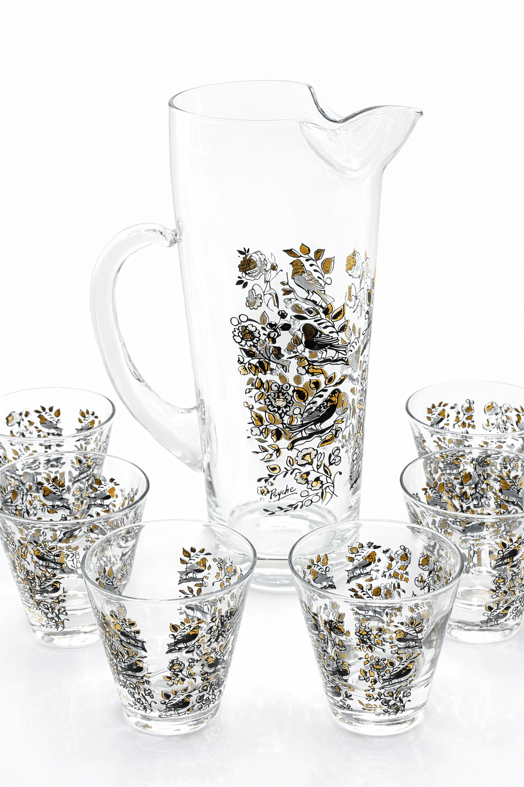Set of glass pitcher and tumblers with floral patterns on a white background
