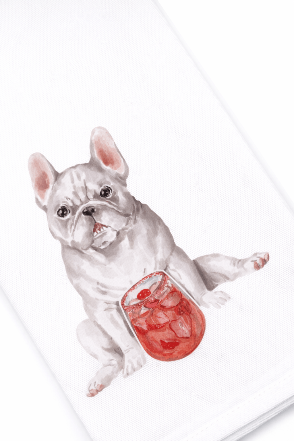 Grey dog holding a glass of red liquid with ice cubes on a white background