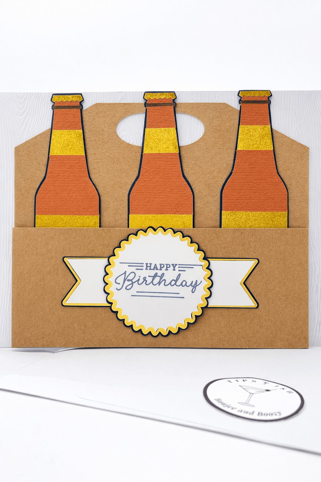 Birthday card with three beer bottles and a 'Happy Birthday' label on a white background.