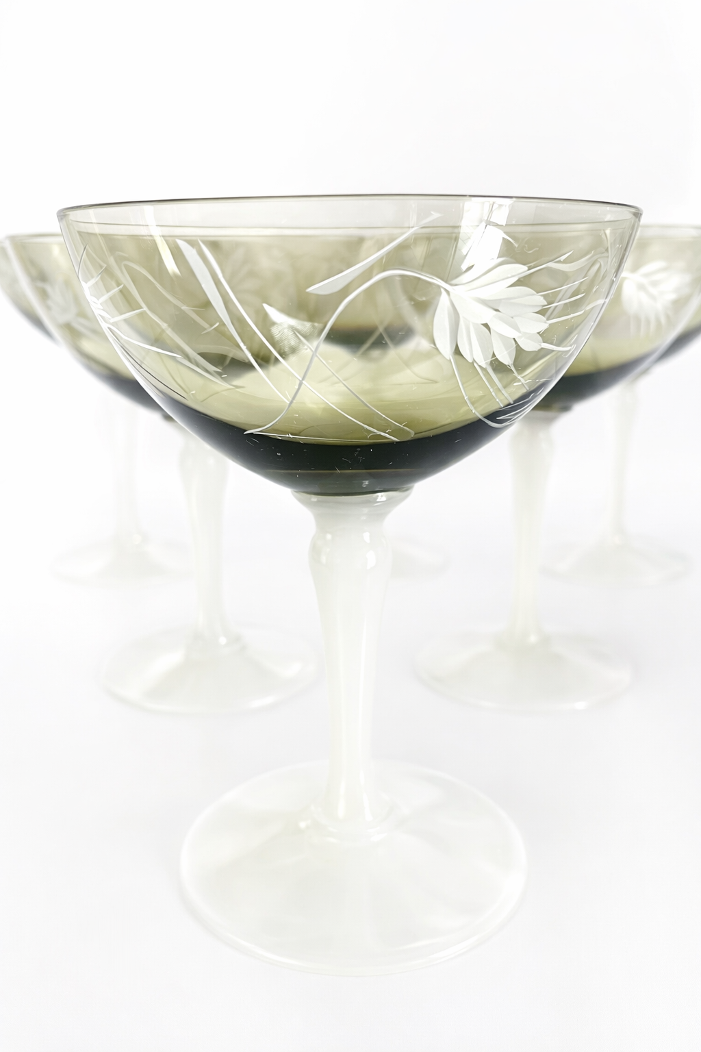 Art Deco opaline champagne coupes with etched smoke glass bowls and milk glass stems