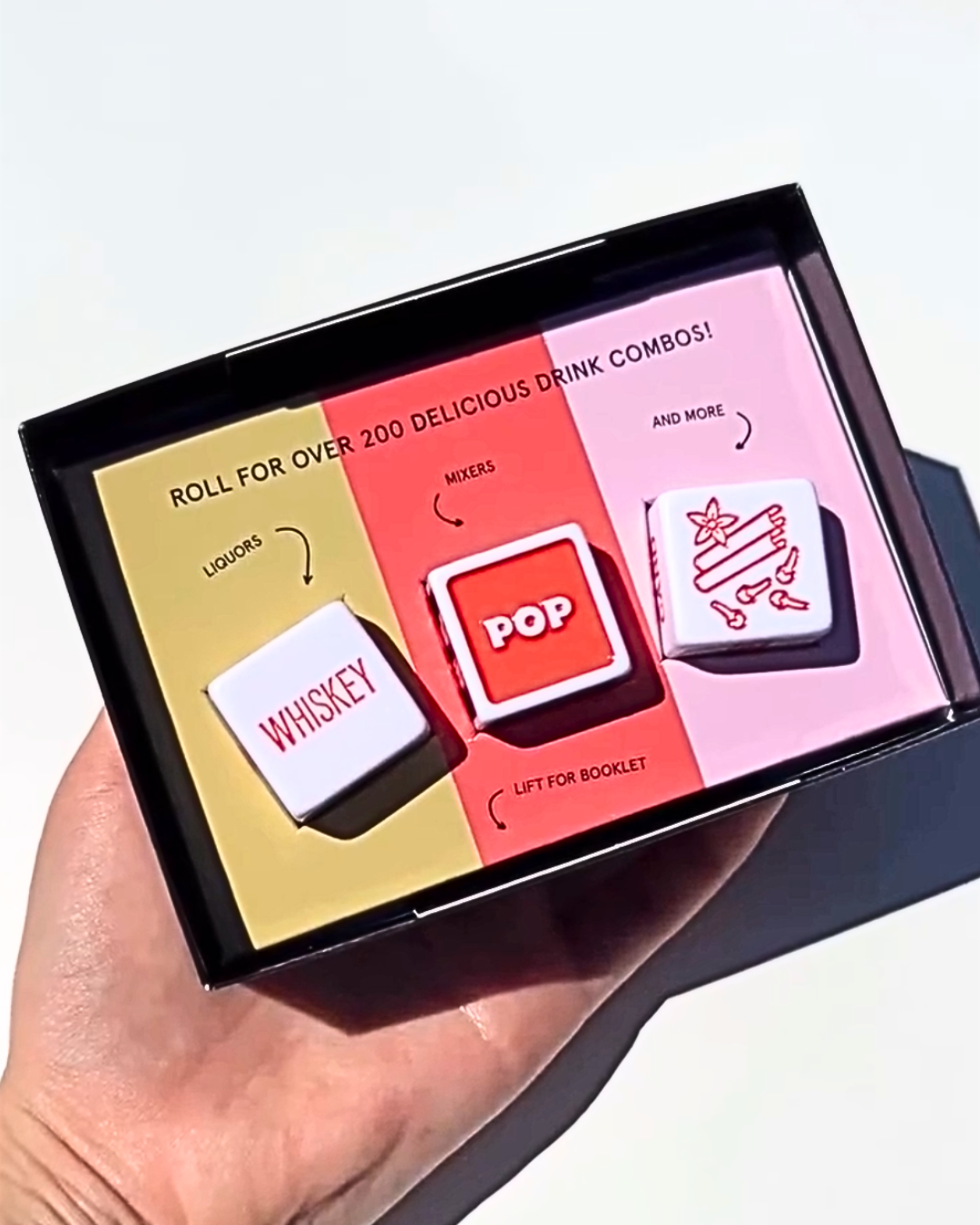 Cocktail Dice game set with liquor, mixer, and garnish dice inside the box, a fun interactive gift for cocktail lovers and home bartenders.