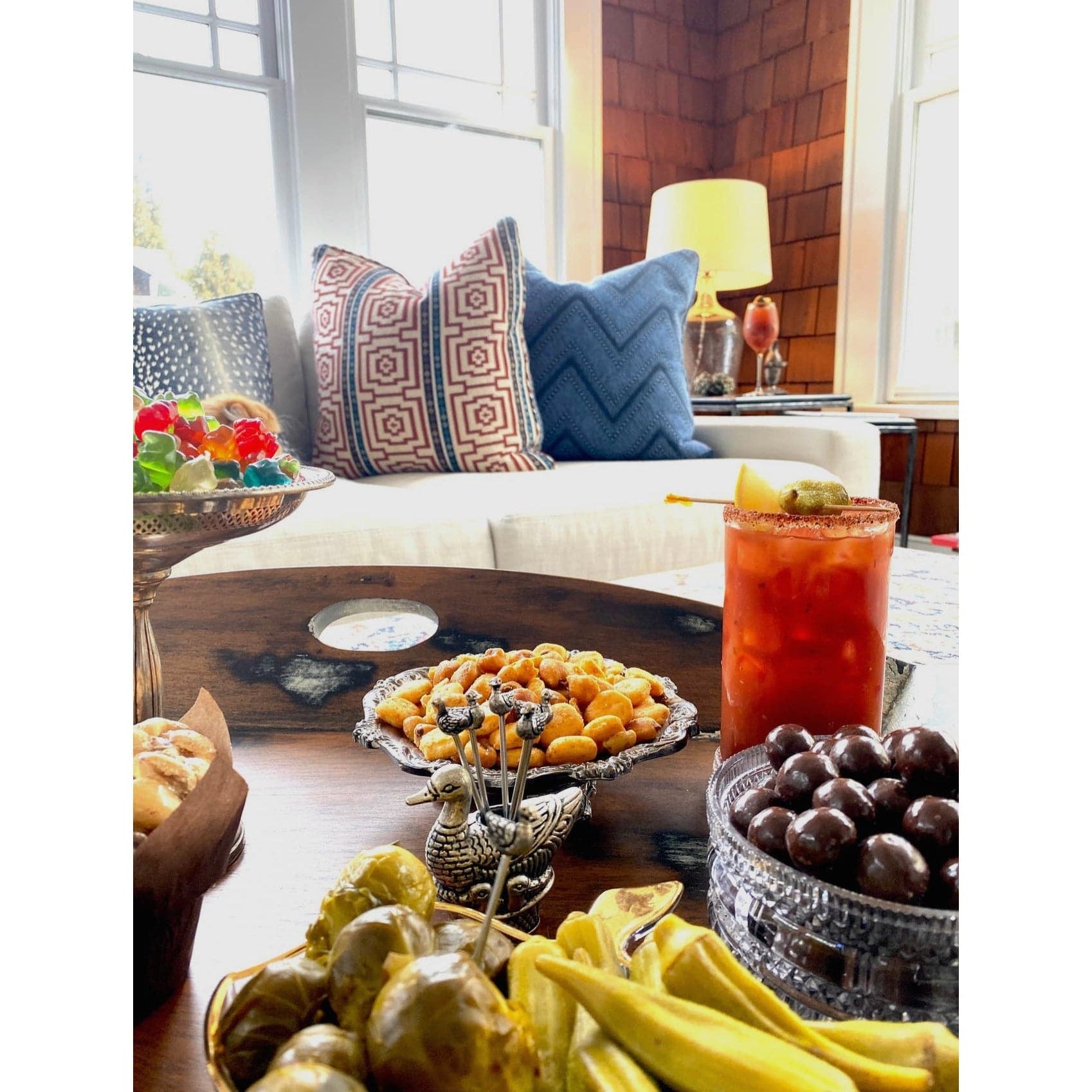 Bloody Mary with party snacks and cocktail garnishes