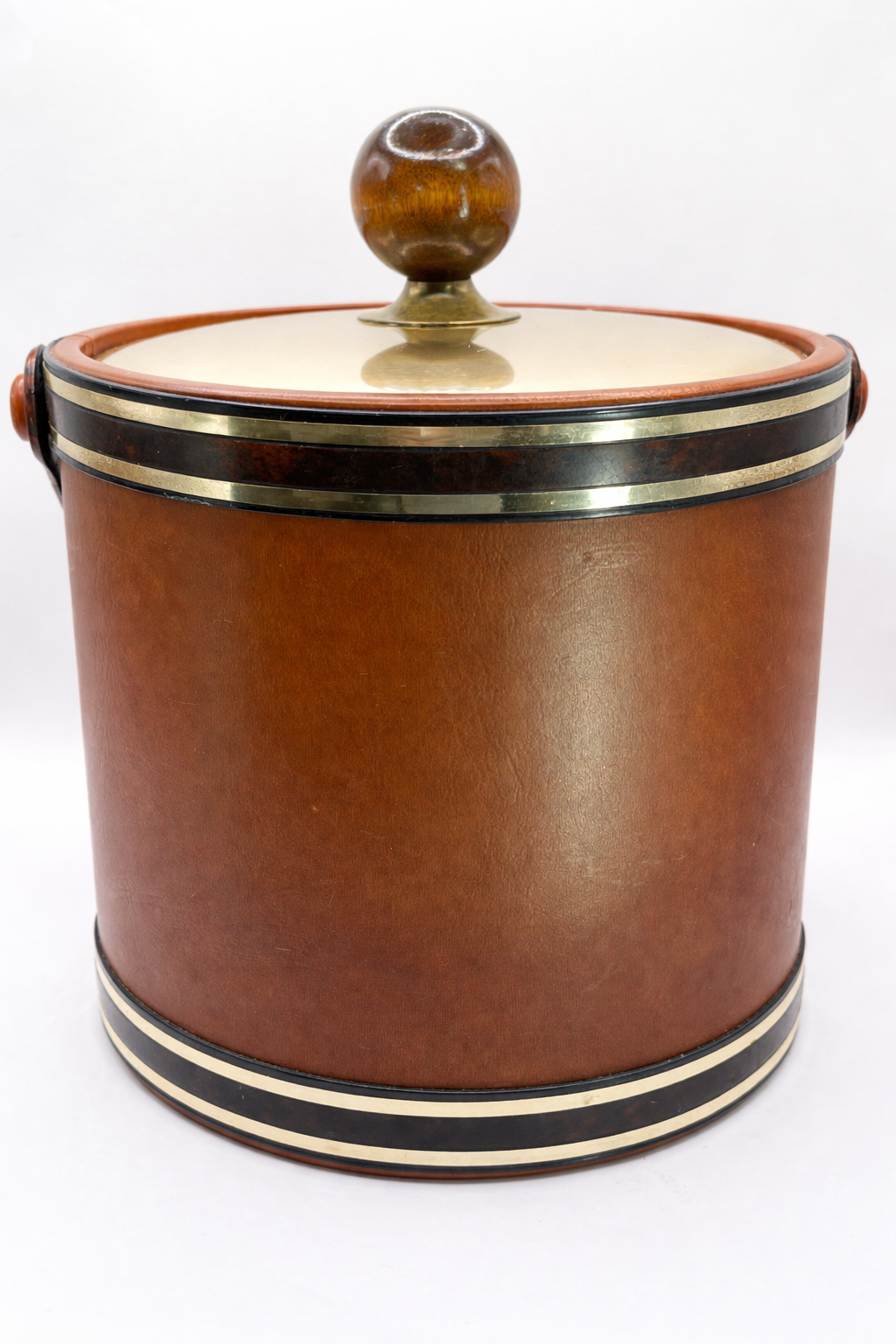 Close view of vintage Kraftware ice bucket showing brass lid and lucite finial knob