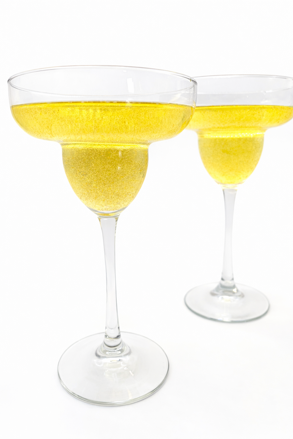 Two mango margarita cocktails in coupe glasses, perfect for entertaining or cocktail parties