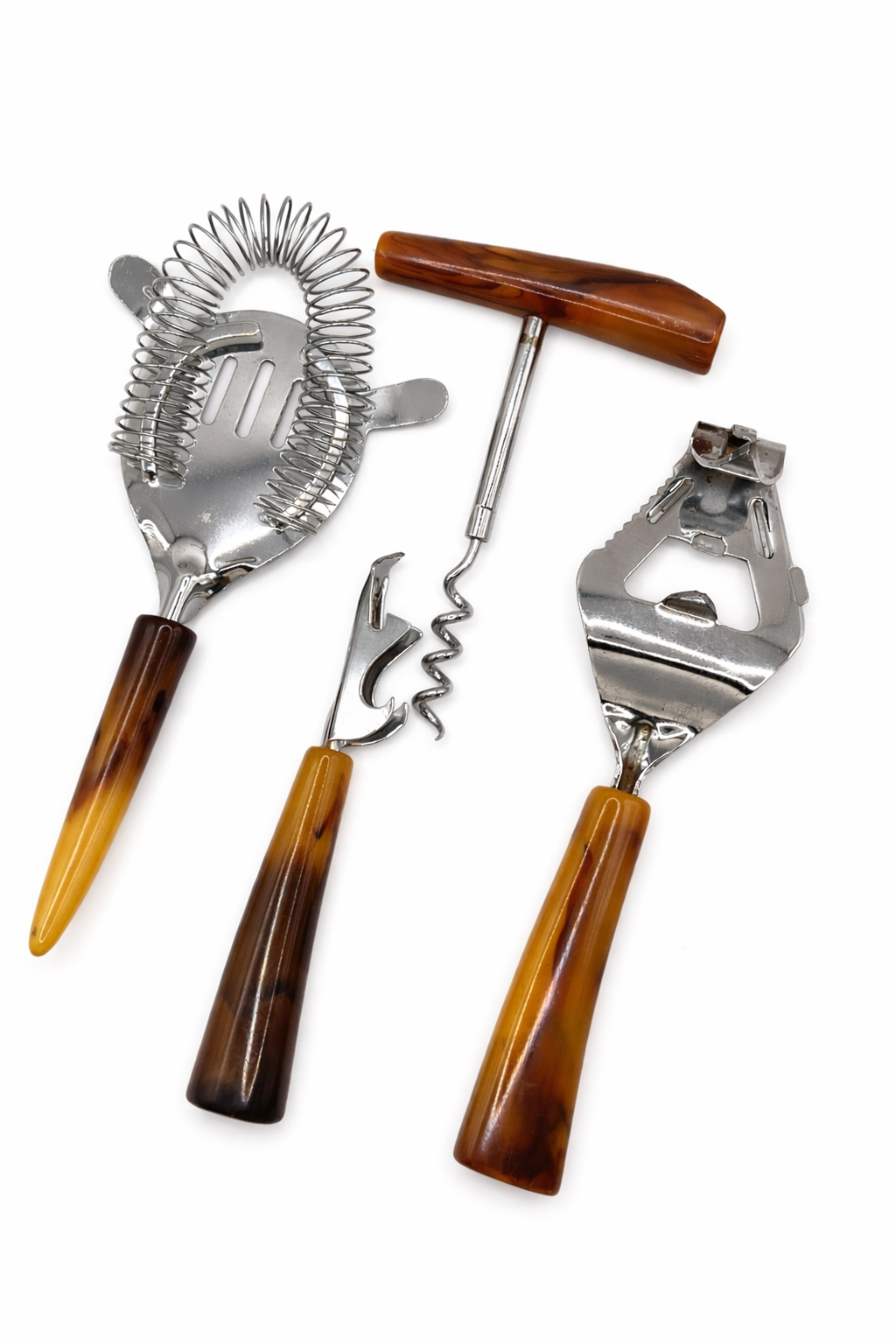 Vintage Bakelite barware tool set with butterscotch swirl handles and chrome cocktail tools on white background
