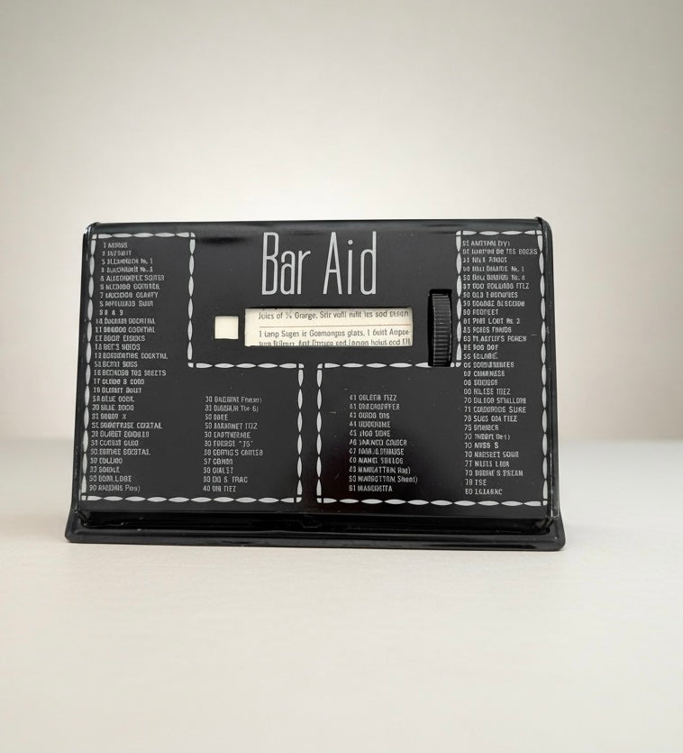 Vintage Bar Aid cocktail recipe selector front view with rotating recipe wheel and black mid century modern design.