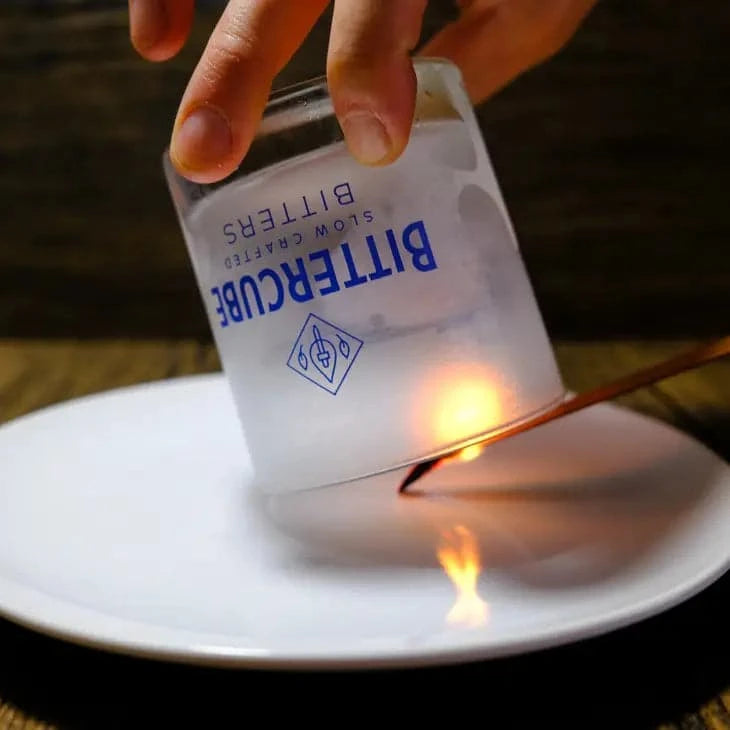 demonstration of a cocktail cedar being used to smoke a glass