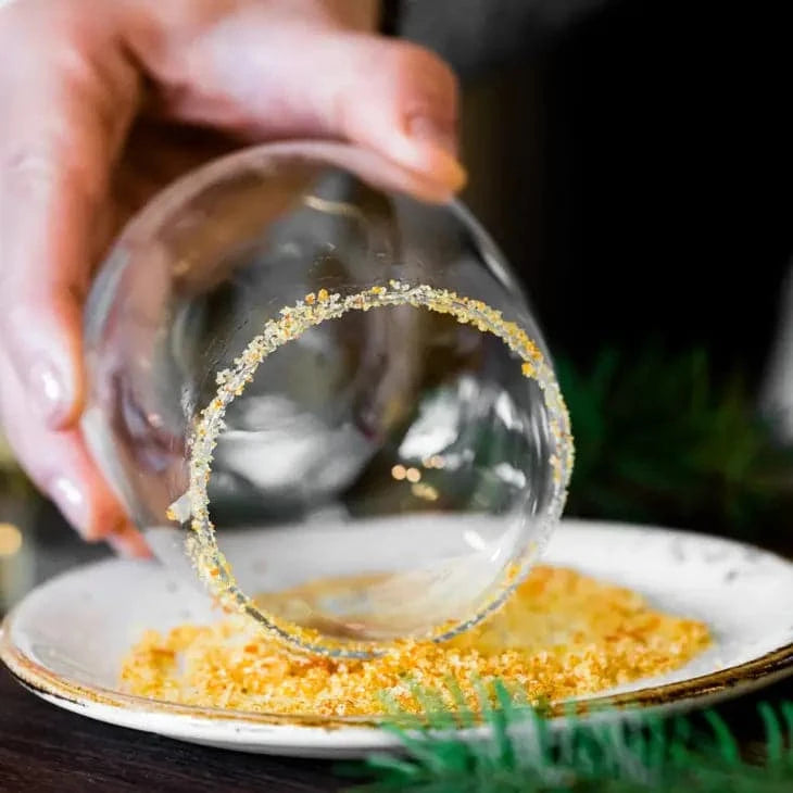 orange blossom finishing sugar being used to rim a wine glass