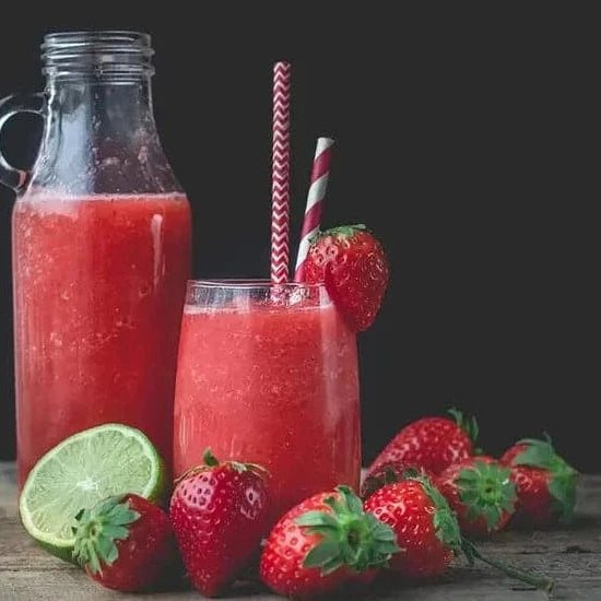 Bottle of Strawberry Daiquiri Wine Slushy Mix – Craft Frozen Cocktail Mixer with a glass full of daiquiri and strawberries on a wood table