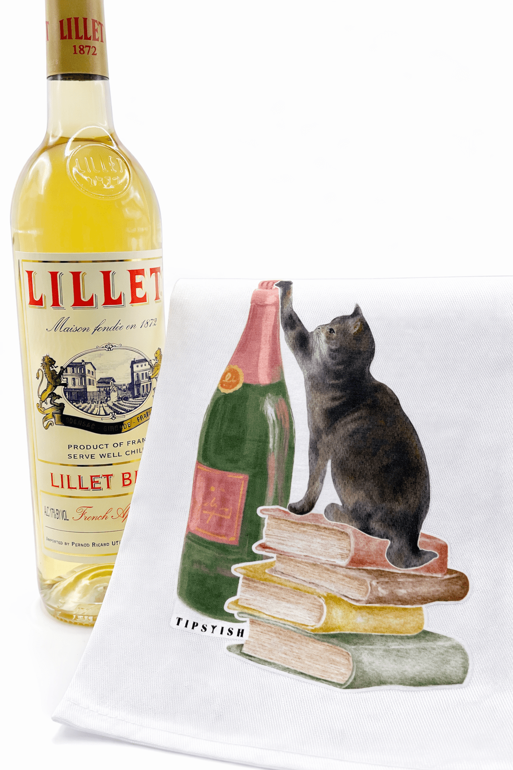 Bottle of Lillet with a decorative towel featuring a cat and bottles design.
