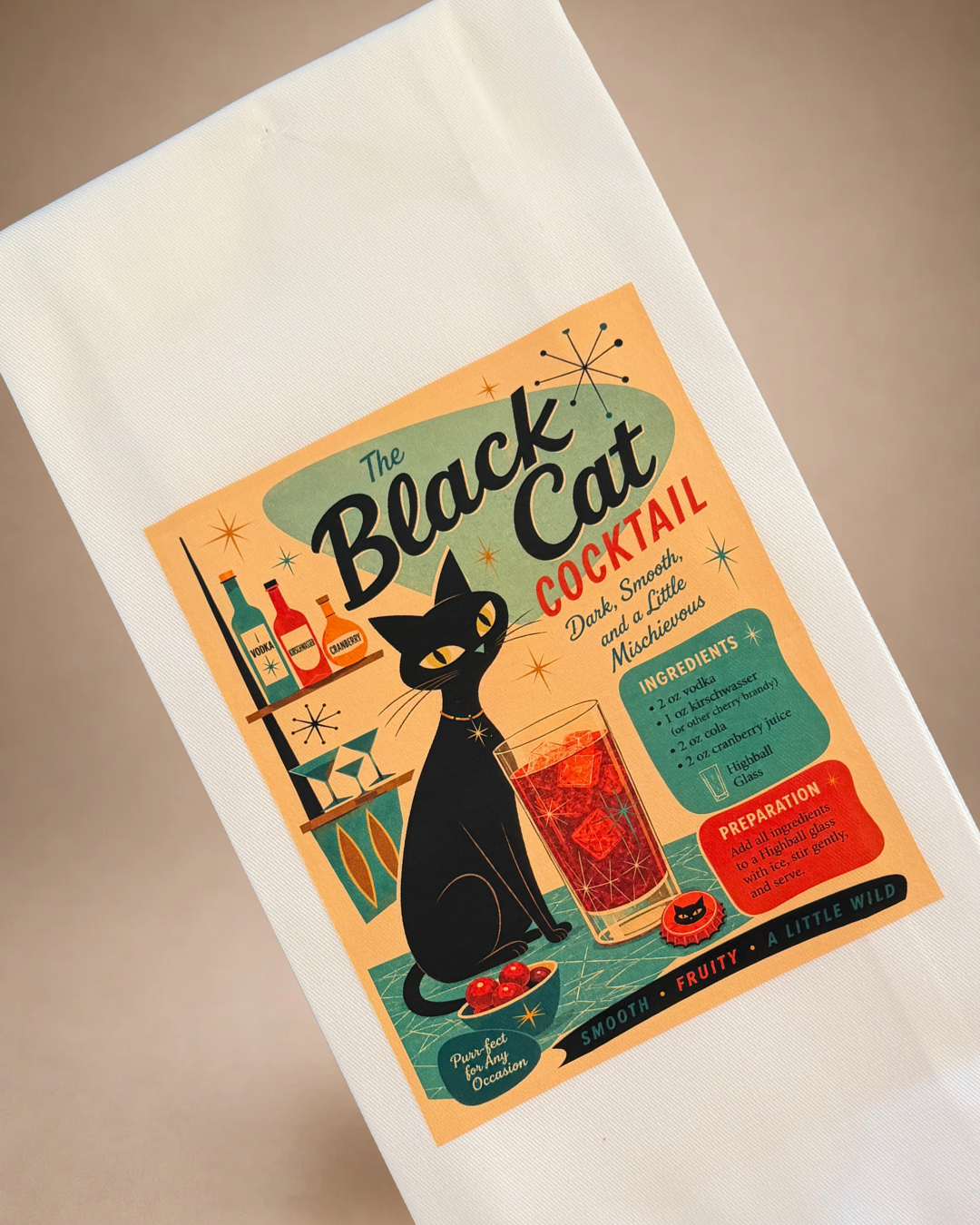Close-up of Black Cat Cocktail tea towel with retro black cat artwork, cocktail recipe and colorful midcentury graphics.