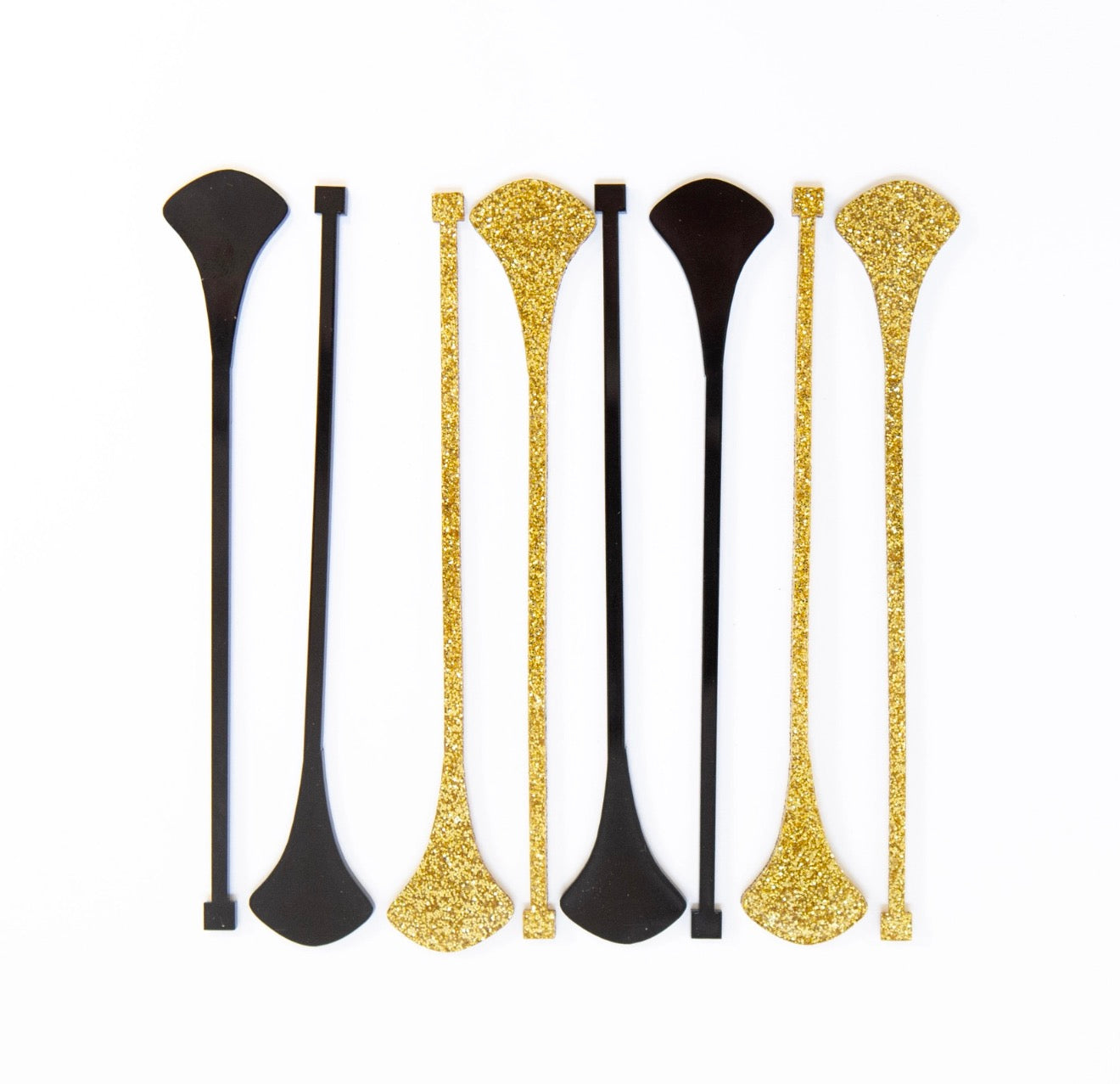 Set of eight black and gold glitter acrylic drink stirrers featuring a Mid Century Modern dart design.