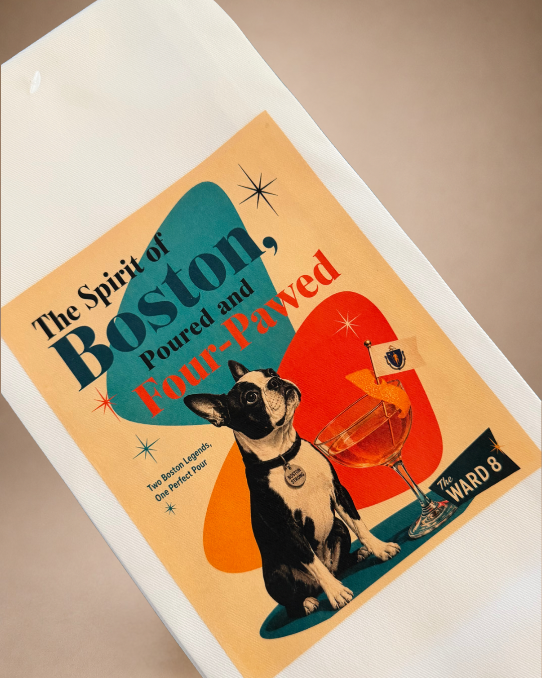 Close-up of retro Boston Terrier and Ward 8 cocktail artwork printed on a white decorative tea towel.