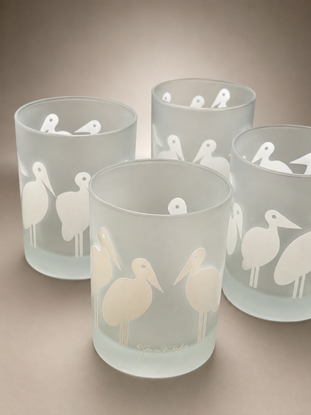 Group display of vintage Georges Briard frosted bird cocktail glasses perfect for MCM entertaining.