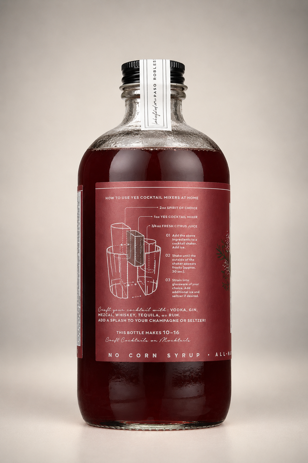 Back of Yes Cocktail Co. Cranberry Spice Mixer bottle showing cocktail preparation instructions, recommended spirit ratios, and serving suggestions for festive holiday drinks.