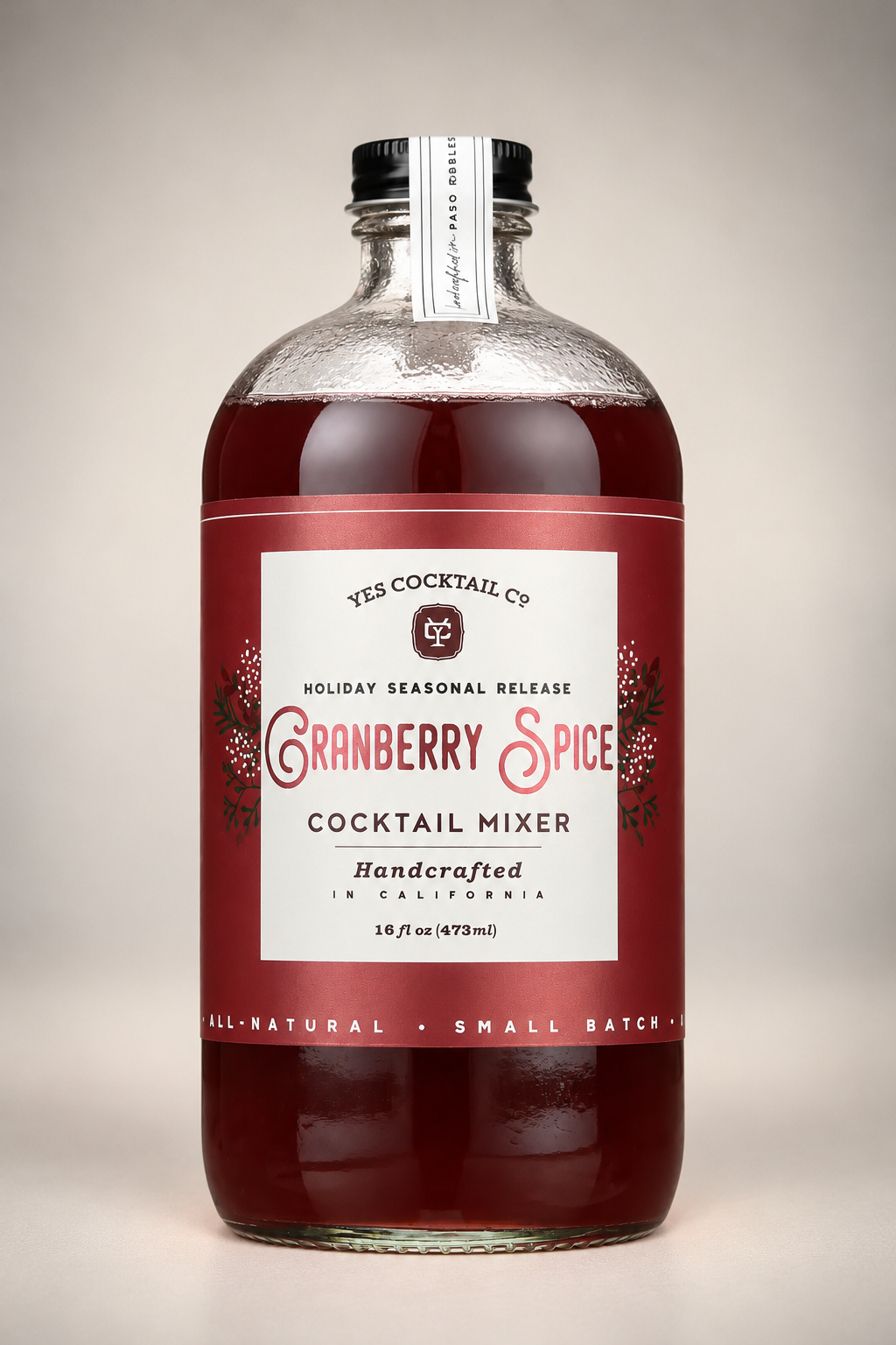 Yes Cocktail Co. Cranberry Spice Cocktail Mixer in a 16 oz glass bottle with festive red label, featuring tart cranberry and warm holiday spices for Christmas cocktails and mocktails.