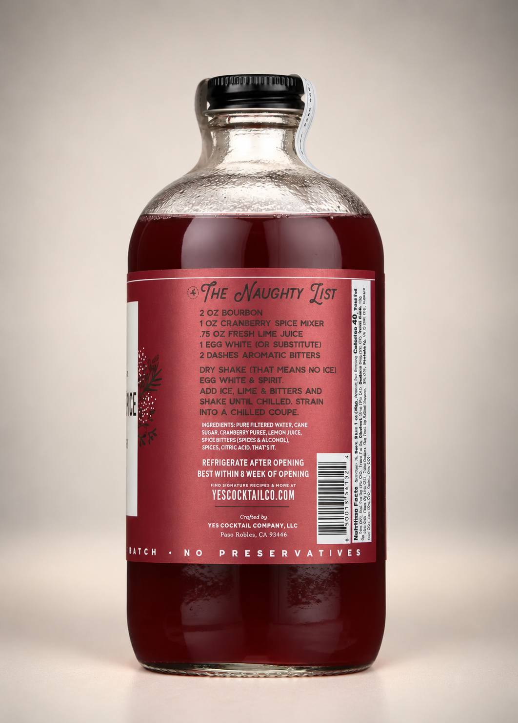Yes Cocktail Co. Cranberry Spice Cocktail Mixer back label featuring The Naughty List bourbon cocktail recipe, ingredients, nutrition facts, and storage instructions.