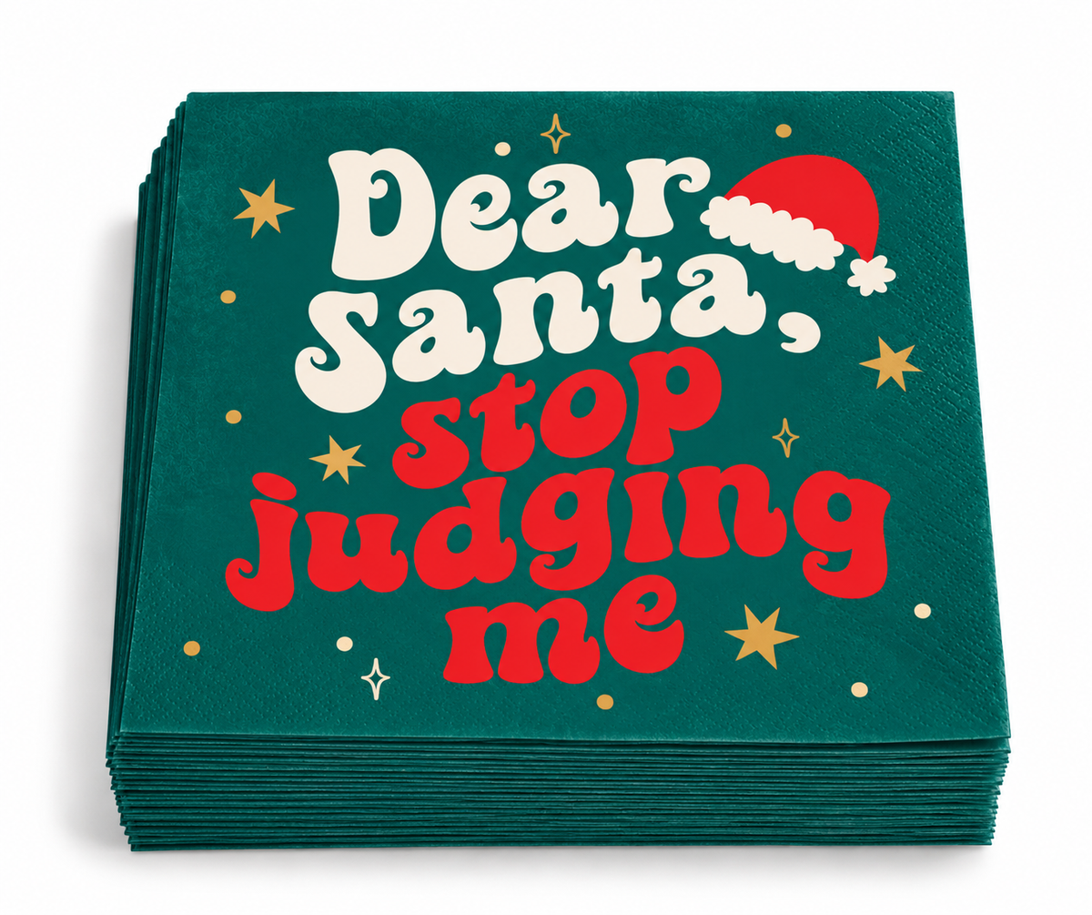 Stack of 20 teal green Dear Santa Stop Judging Me Christmas beverage napkins with retro red and cream lettering and gold star accents.