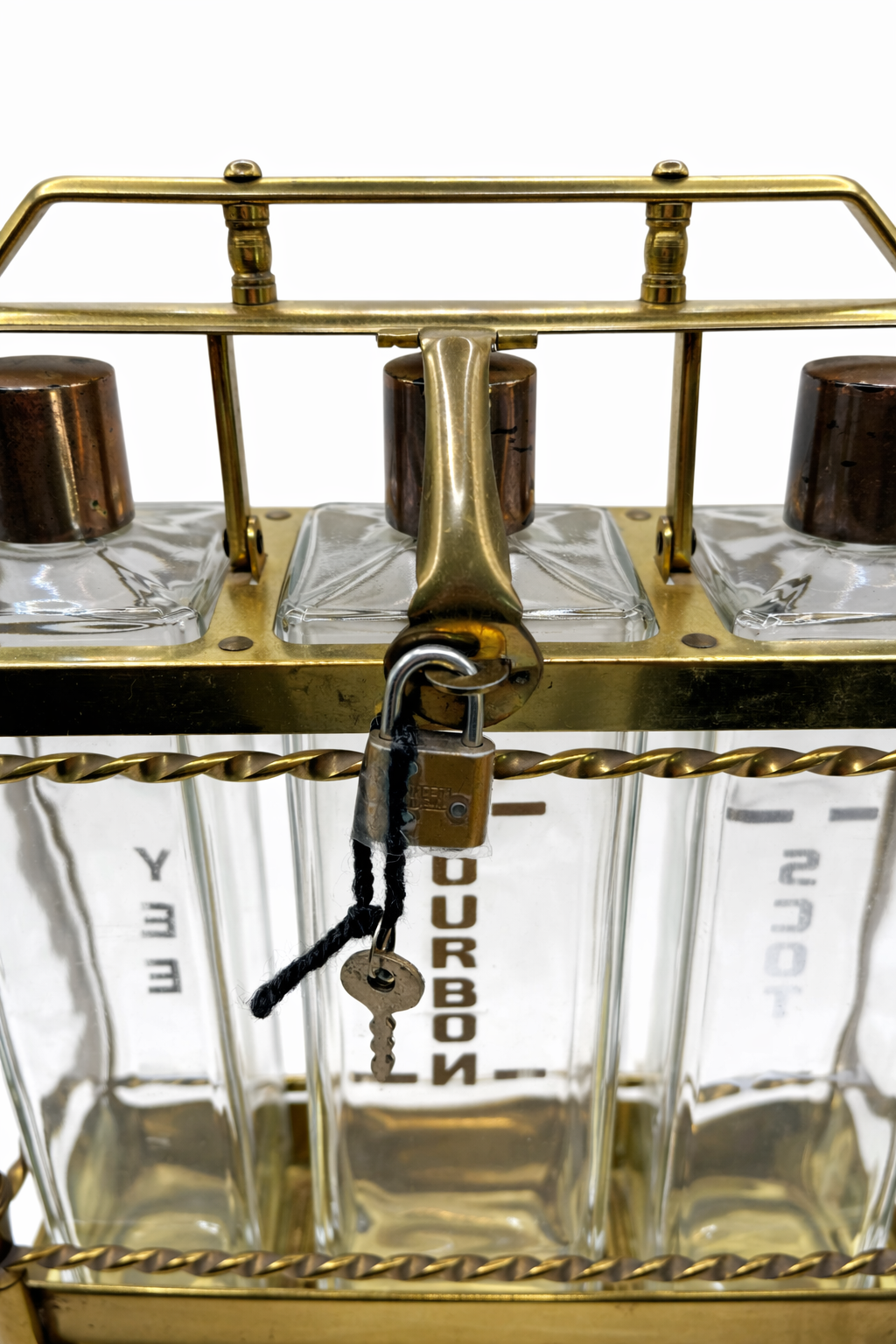Close up of working brass lock and key on mid century modern liquor decanter set