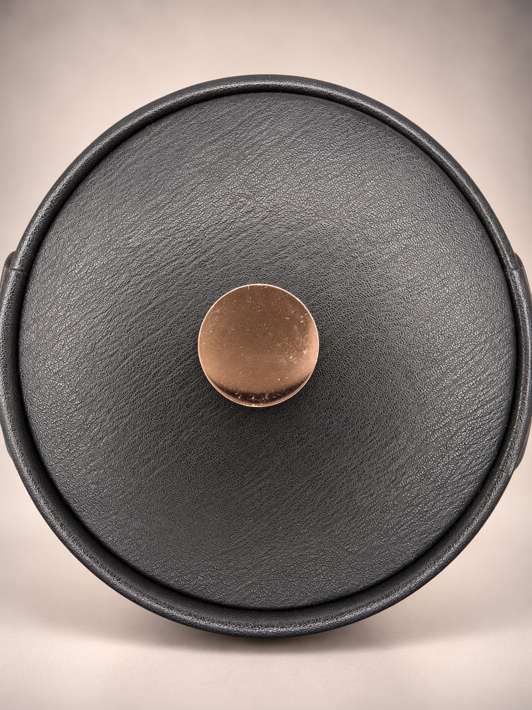 Overhead photograph of vintage Elmar ice bucket lid showing black textured finish and silver-tone center knob.