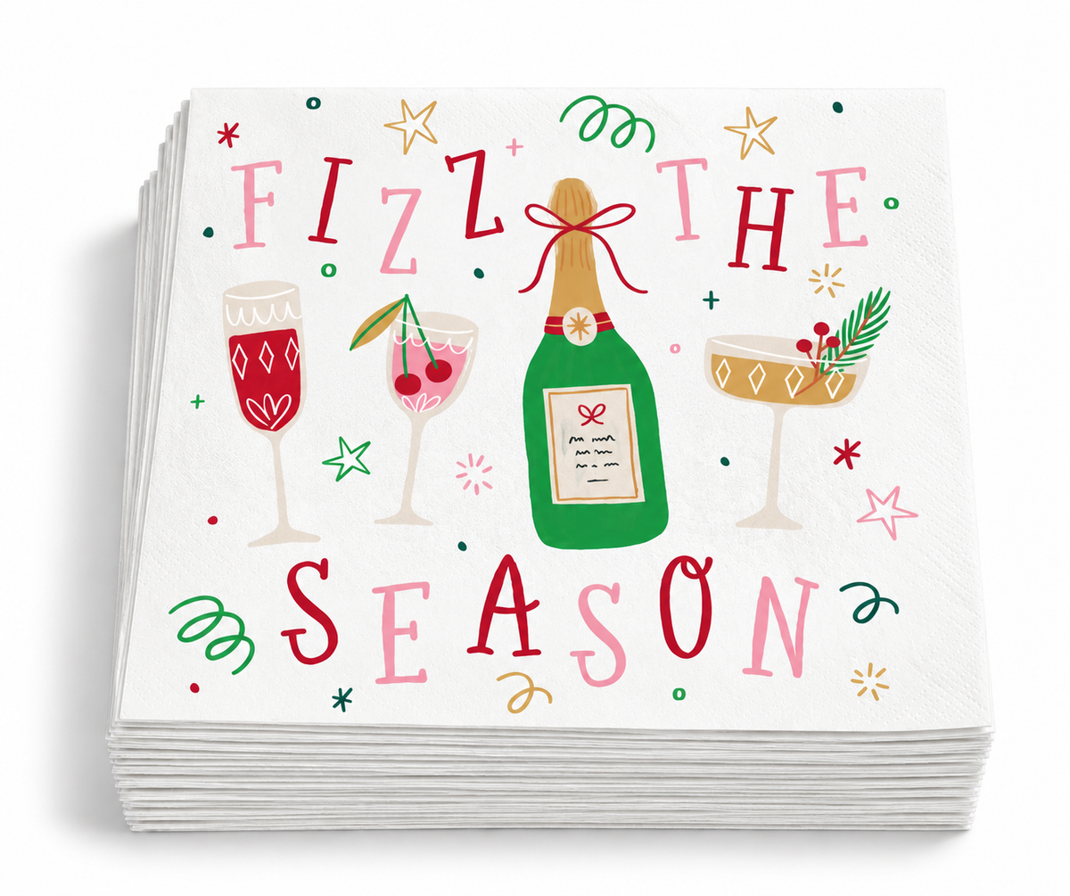 Stack of Fizz the Season Christmas beverage napkins featuring champagne and festive cocktail illustrations on a white background.