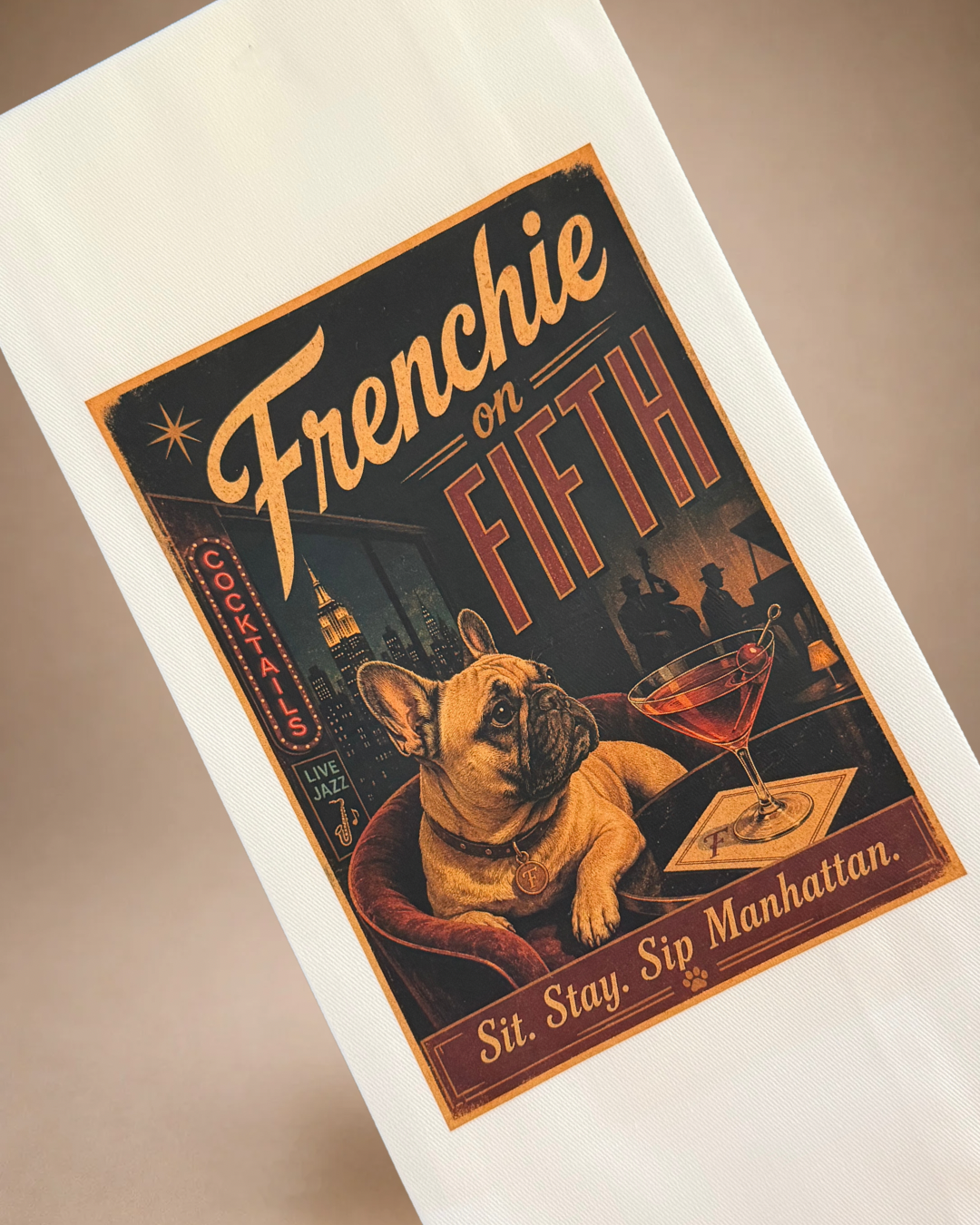 Close-up of Frenchie on Fifth tea towel with French Bulldog, Manhattan cocktail and Sit Stay Sip Manhattan design.