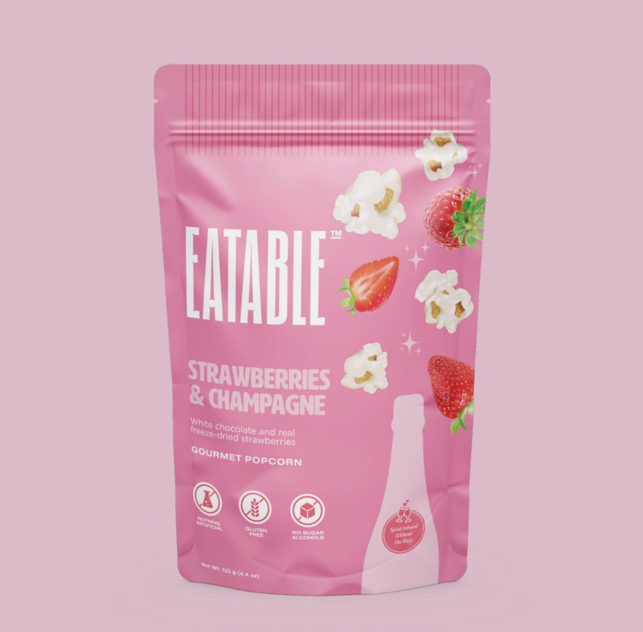 Pink package of Eatable Strawberries & Champagne Gourmet Popcorn on a pink background