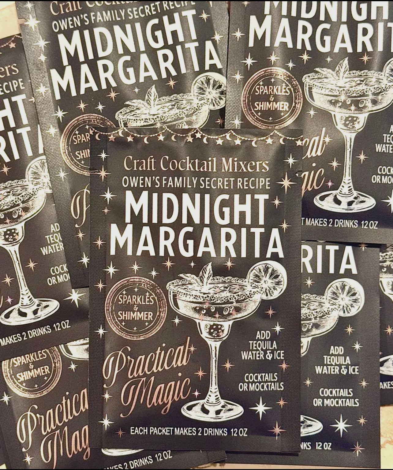 Packages of Midnight Margarita cocktail mixers with decorative text and graphics.