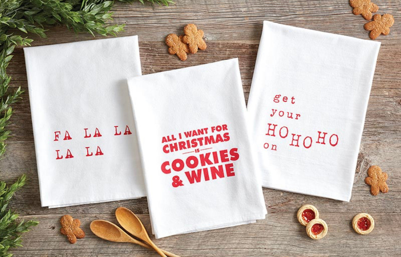 display of christmas towels with christmas cookies on a wood background