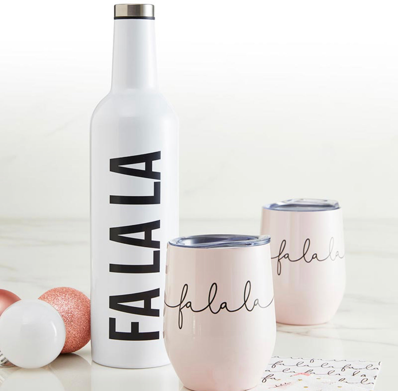 "fa la la" stainless steel wine bottle shown with christmas wine tumblers