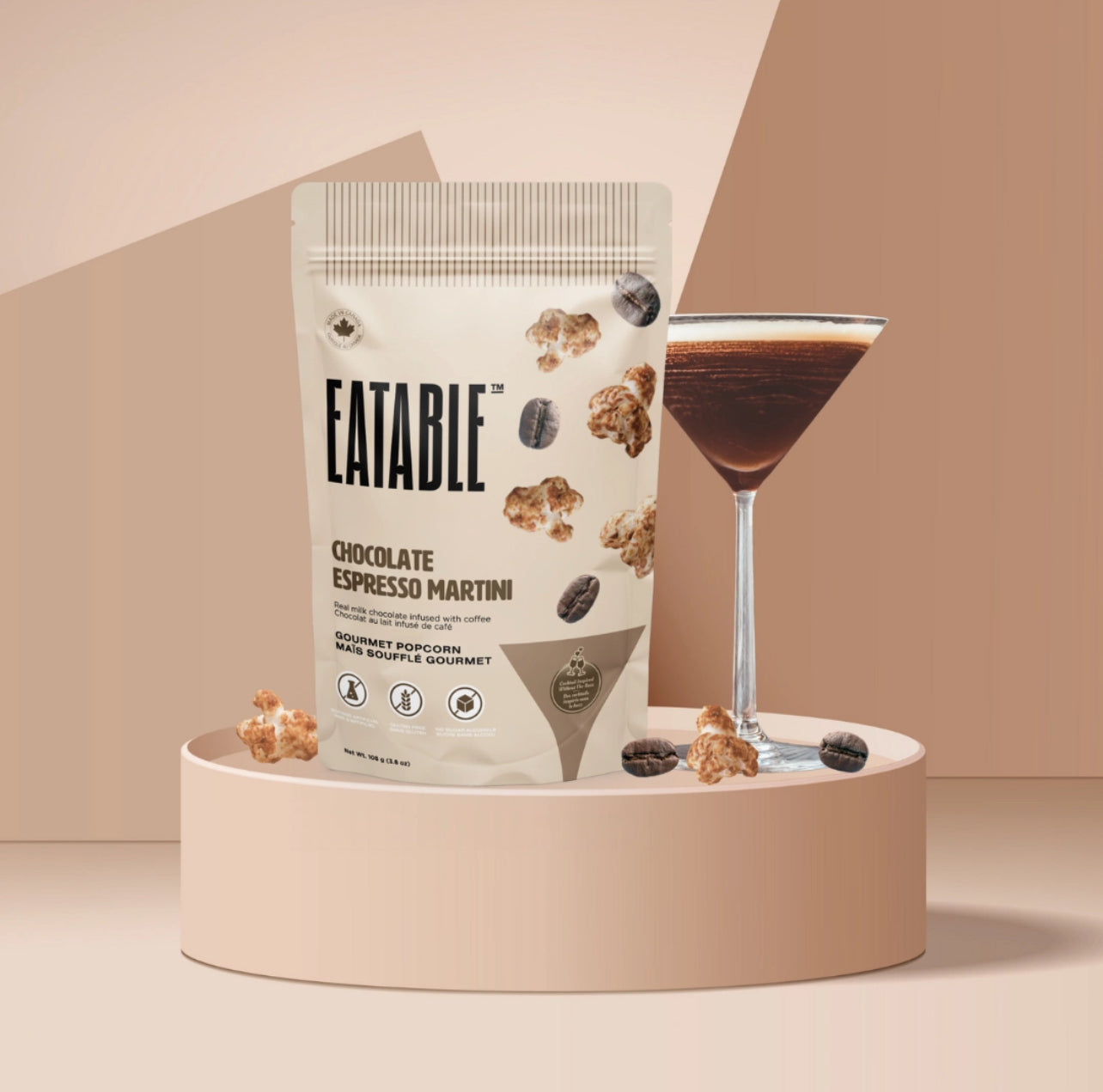 Eatable chocolate espresso martini packaging with a glass of the drink on a beige background