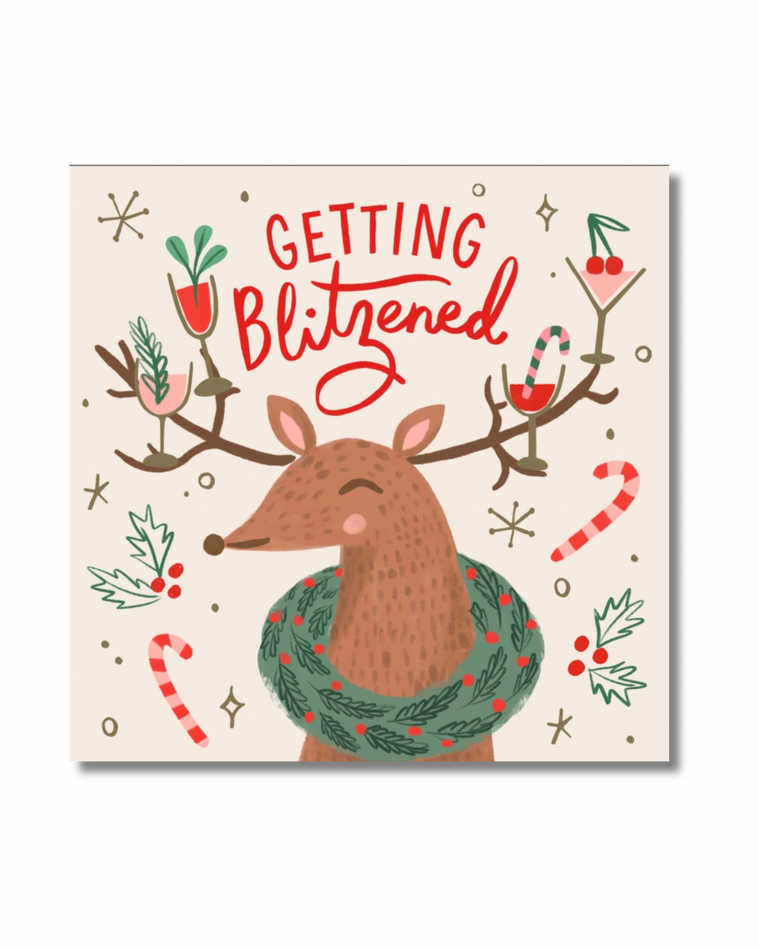 Cream Christmas cocktail napkin featuring a festive reindeer, holiday cocktails, candy canes and red Getting Blitzened lettering.
