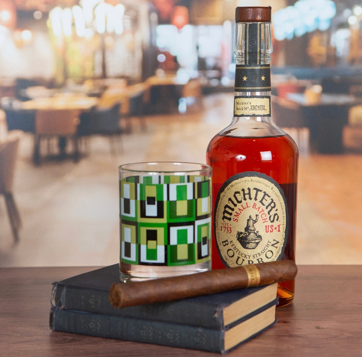 Mid century inspired green square whiskey glass displayed with bourbon bottle and cigar