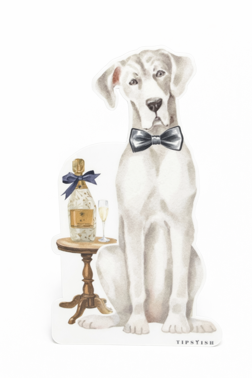Grey dog with a bow tie sitting next to a bottle on a small table