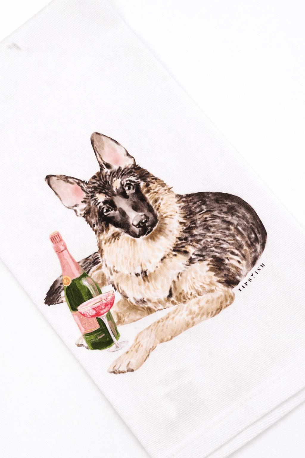 Tea towel with a German Shepherd and champagne bottle design on a white background
