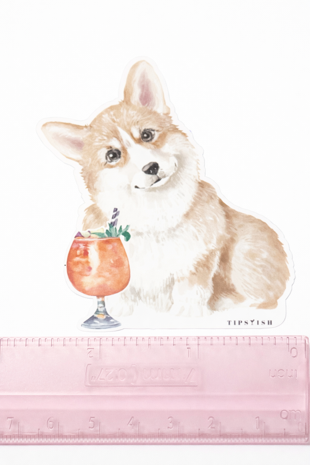 Illustration of a corgi holding a cocktail with a ruler at the bottom for scale.