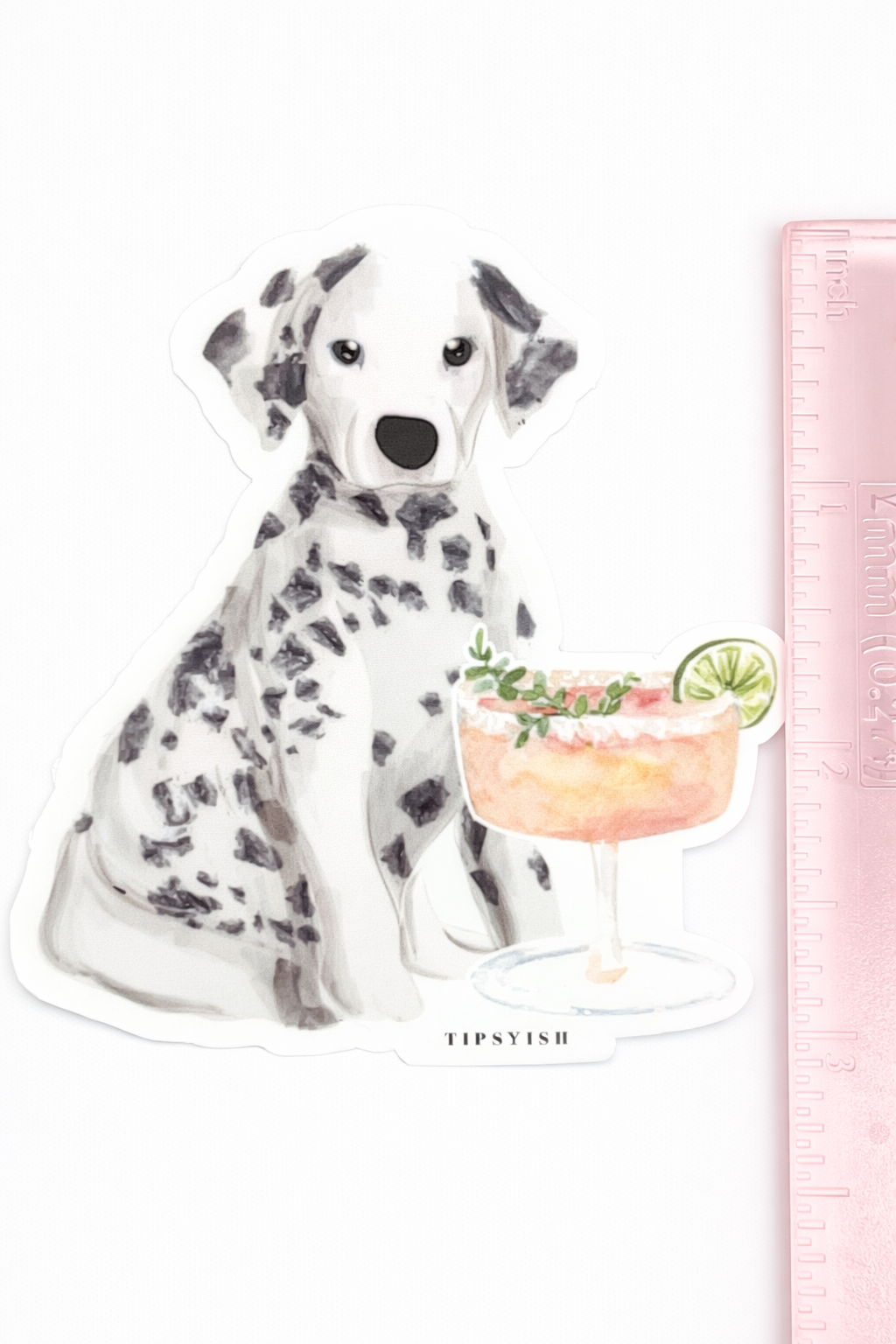 Sticker of a Dalmatian dog with a cocktail next to a ruler for scale