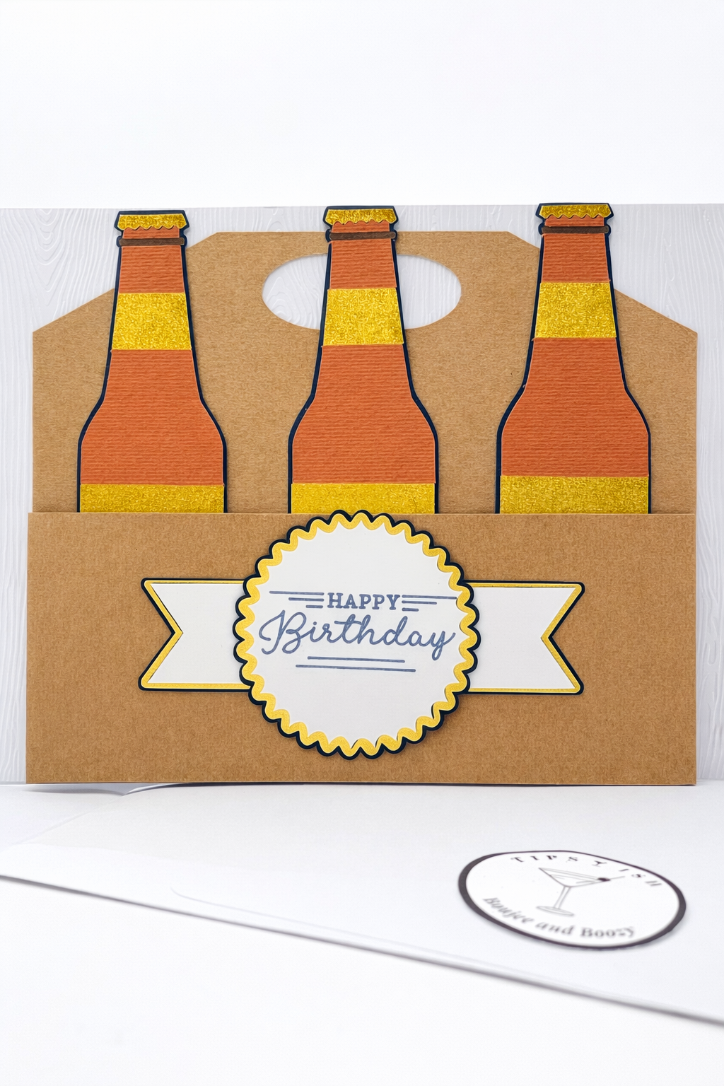 Birthday card with three beer bottles and a 'Happy Birthday' label on a white background.