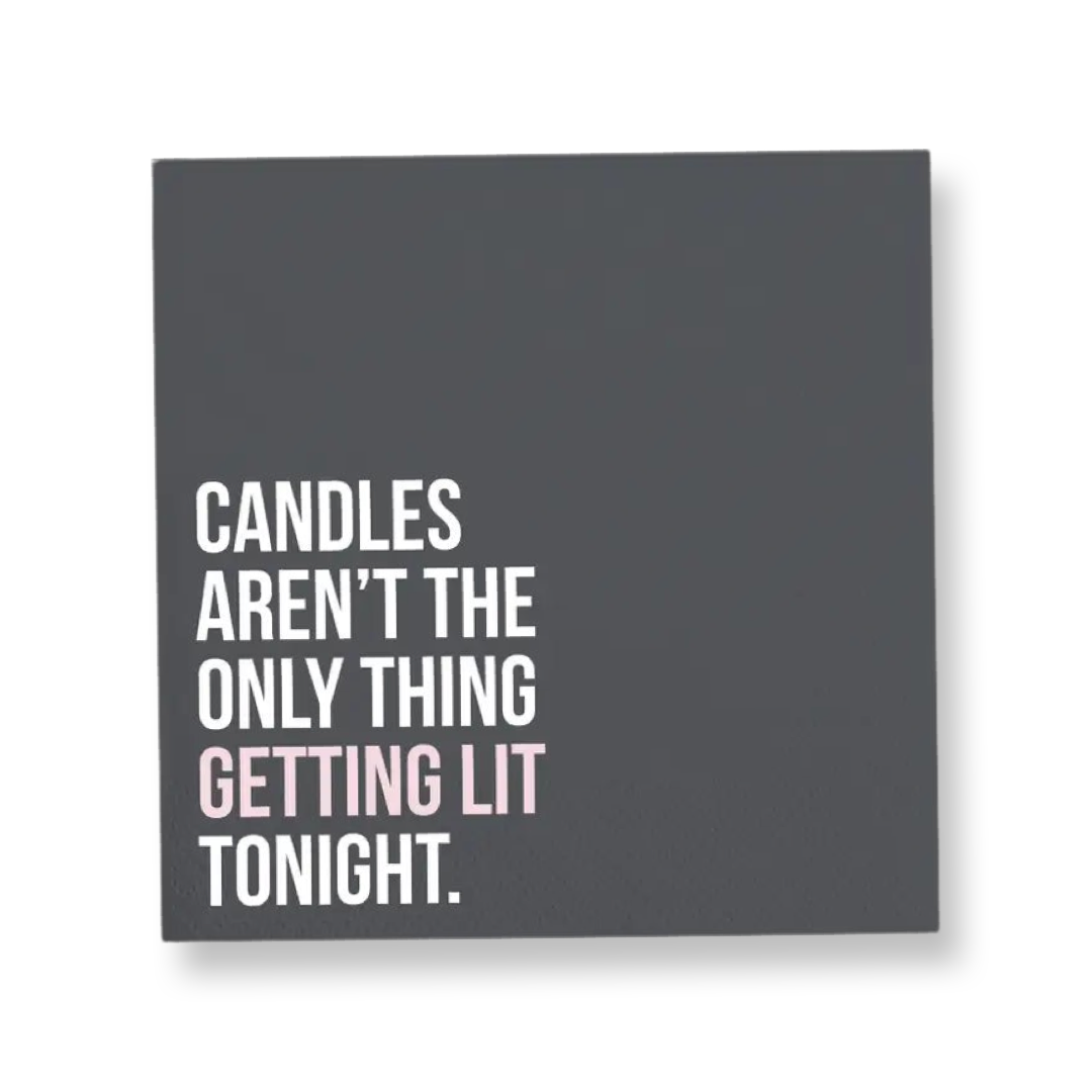 5" x 5" black square paper napkin with the words "Candles Aren't The Only Thing Getting Lit Tonight" in white, while the words "getting lit" stand out in the color pink
