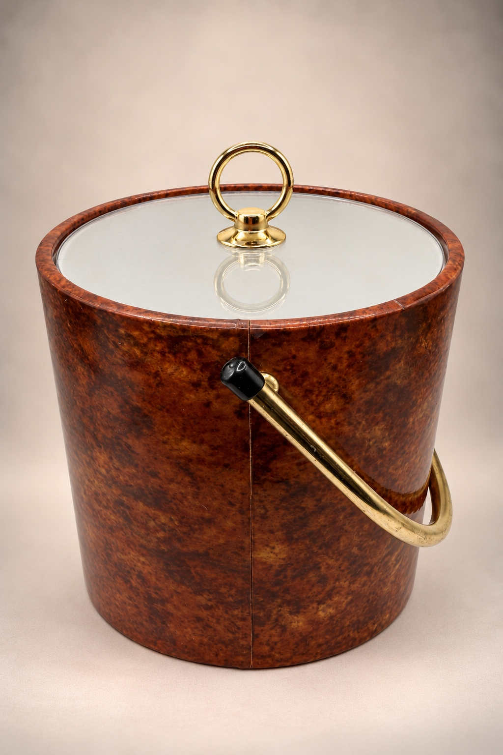 Angled view of retro brown ice bucket showing mottled exterior, gold-tone handle and fitted lid.