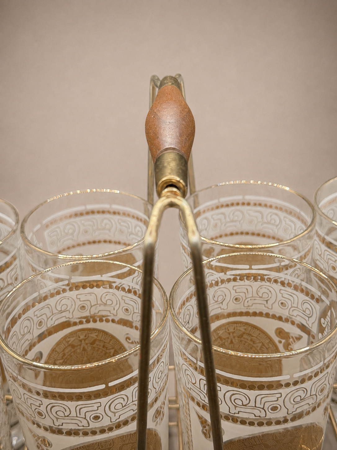 Overhead perspective showing the turned wood handle and eight matching vintage cocktail glasses.